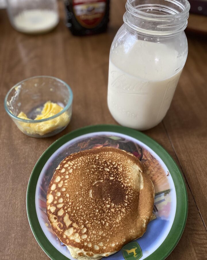 Photo of pancakes, fresh milk, and fresh scrambled eggs